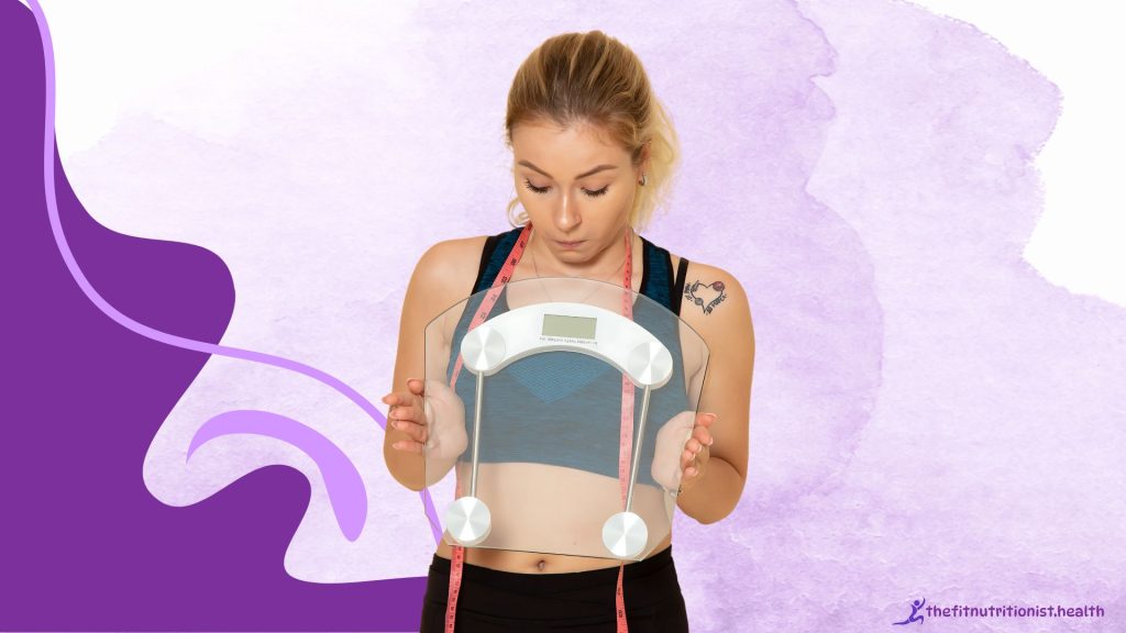beginner workout plan image, woman holding a scale and looking down at it